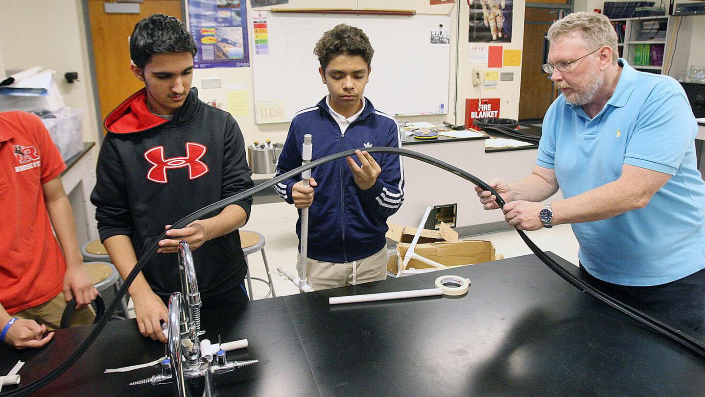 Photo Gallery: 8th grade Theodore Roosevelt Middle School students make roller coasters in physical science class