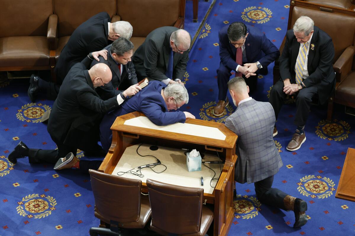 Rep. Mike Johnson and fellow Republicans pray together in the House Chamber.