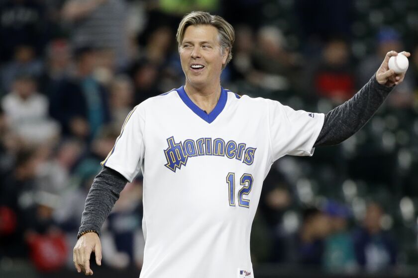 Former Seattle Mariners pitcher Mark Langston throws out the ceremonial first pitch before a baseball game between the Mariner and the Los Angeles Angels Tuesday, May 2, 2017, in Seattle. (AP Photo/Elaine Thompson)