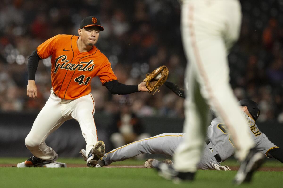 San Francisco Giants third baseman Wilmer Flores (41) catches the throw in time to force out Pittsburgh Pirates' Josh VanMeter (26) at third base during the eighth inning of a baseball game Friday, Aug. 12, 2022, in San Francisco. (AP Photo/D. Ross Cameron)
