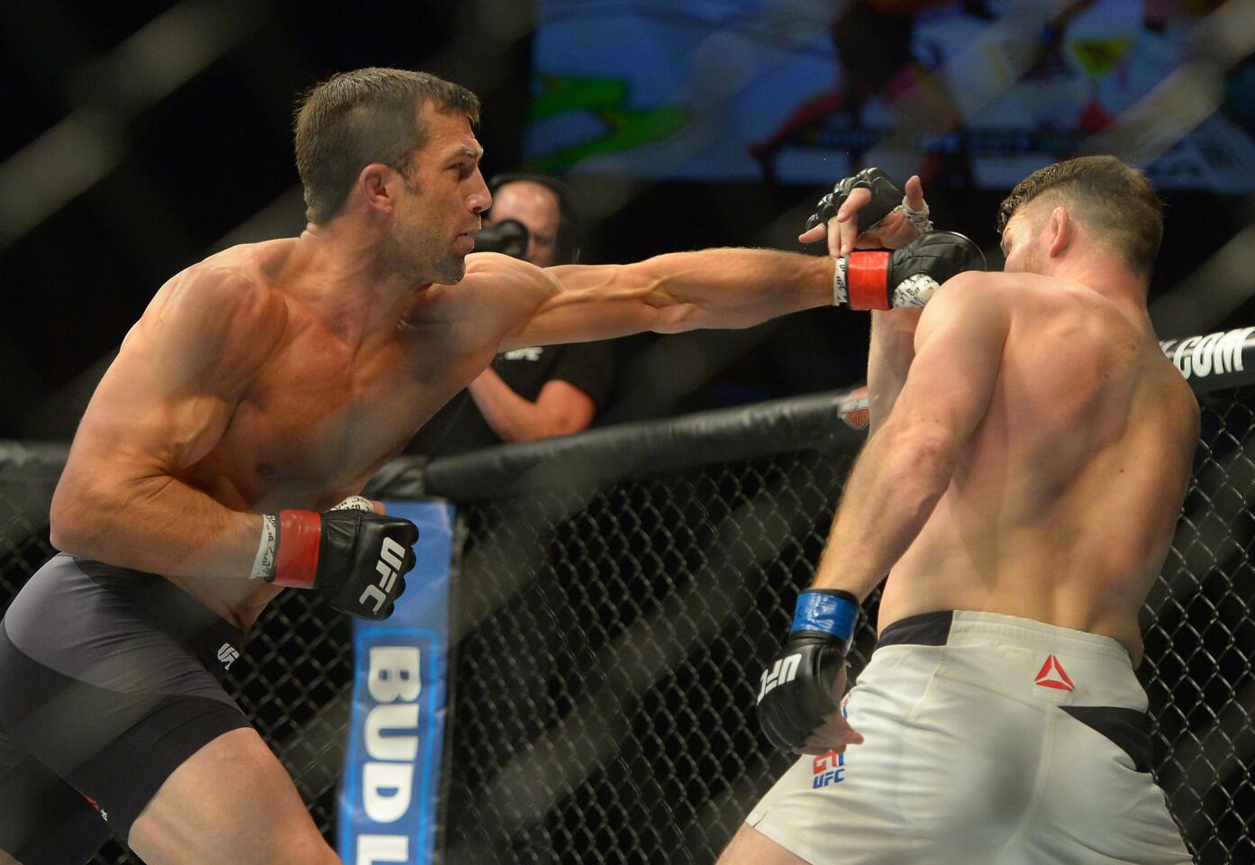 Luke Rockhold throws a left jab at Michael Bisping during their middleweight title fight at UFC 199.