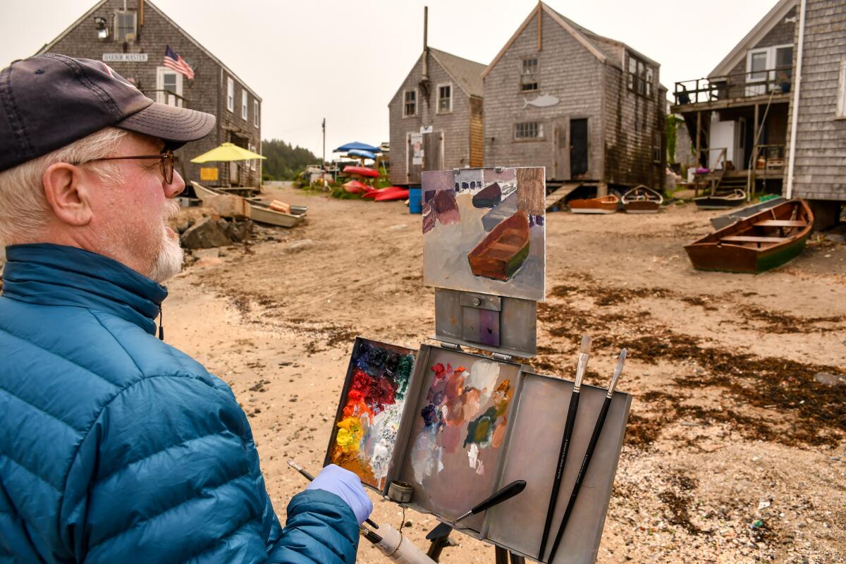 Painters on a beach at Monhegan Island, Maine.