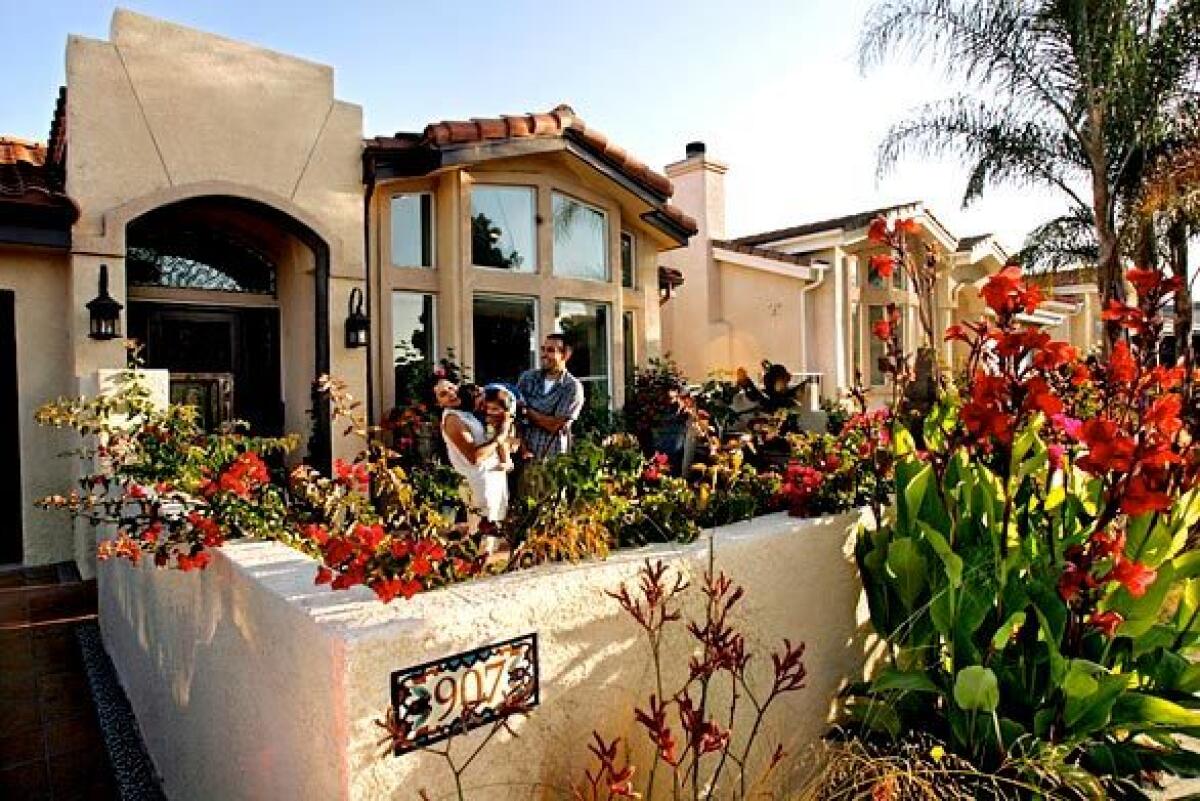 By Eric Ducker Christopher Portugal describes the original look of his home as "California no-style." The 2,500-square-foot house was built in 2004 on a 10,000-square-foot hillside lot in San Pedro. It was, he says, "just an amalgamation of random stucco and tile that you see springing up everywhere, with no general architectural direction or proper contractor supervision." Portugal bought the home when it was in the early stages of construction and moved in with his wife, Ritu, after their honeymoon. They soon started seeing small problems, and when the rainstorms caused flooding, they realized how seriously flawed the building was. "When we moved in, we were looking forward to getting on with our lives," says Portugal, who records under the name Thes One and is a member of the hip-hop duo People Under the Stairs. "I was thinking about touring. I was thinking about doing music." Instead, he immersed himself in fixing up their house, though he had no prior home improvement experience. "It was very dramatic, those first two years. Then I realized I liked doing it," he says. "I liked being outside and being involved with the construction." Take a peek inside the latest installment of our Backstage Pass series on the homes of Southern California's music industry -- homes as entertaining as the personalities on stage and behind the scenes.