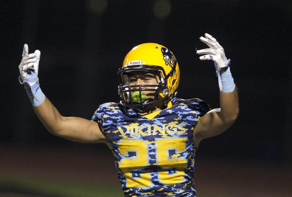 Marina's Brandon Savea celebrates a touchdown against Santa Ana.