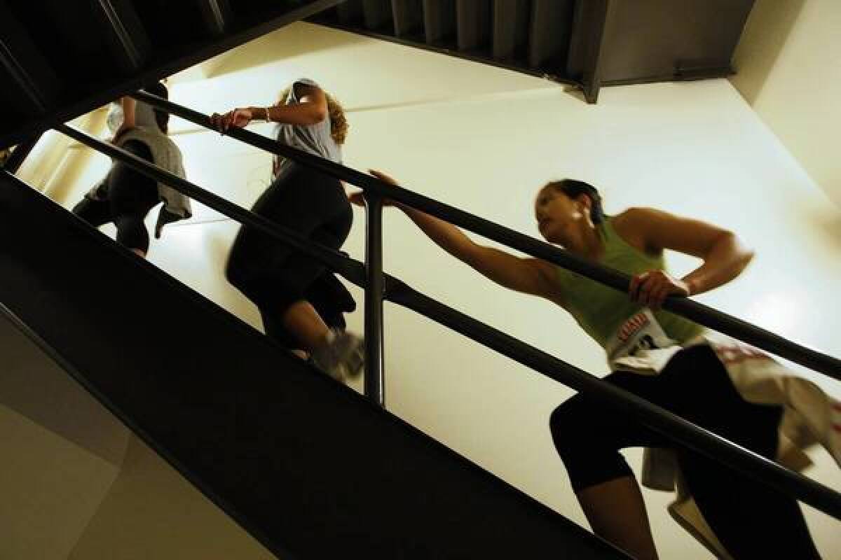 Using the rail as pull-up, a popular technique, Laura Dionisio participates in the Fight for Air Climb in Aon Center.