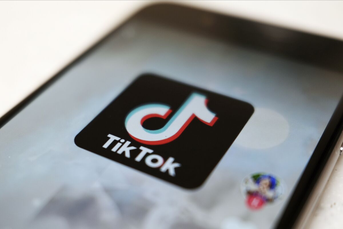 FILE - This Monday, Sept. 28, 2020, file photo, shows the TikTok logo on a smartphone in Tokyo. On Sunday, March 6, 2022, Netflix and TikTok suspended most of their services in Russia as the government cracks down on what people and media outlets can say about Russia's war in Ukraine. (AP Photo/Kiichiro Sato, File)