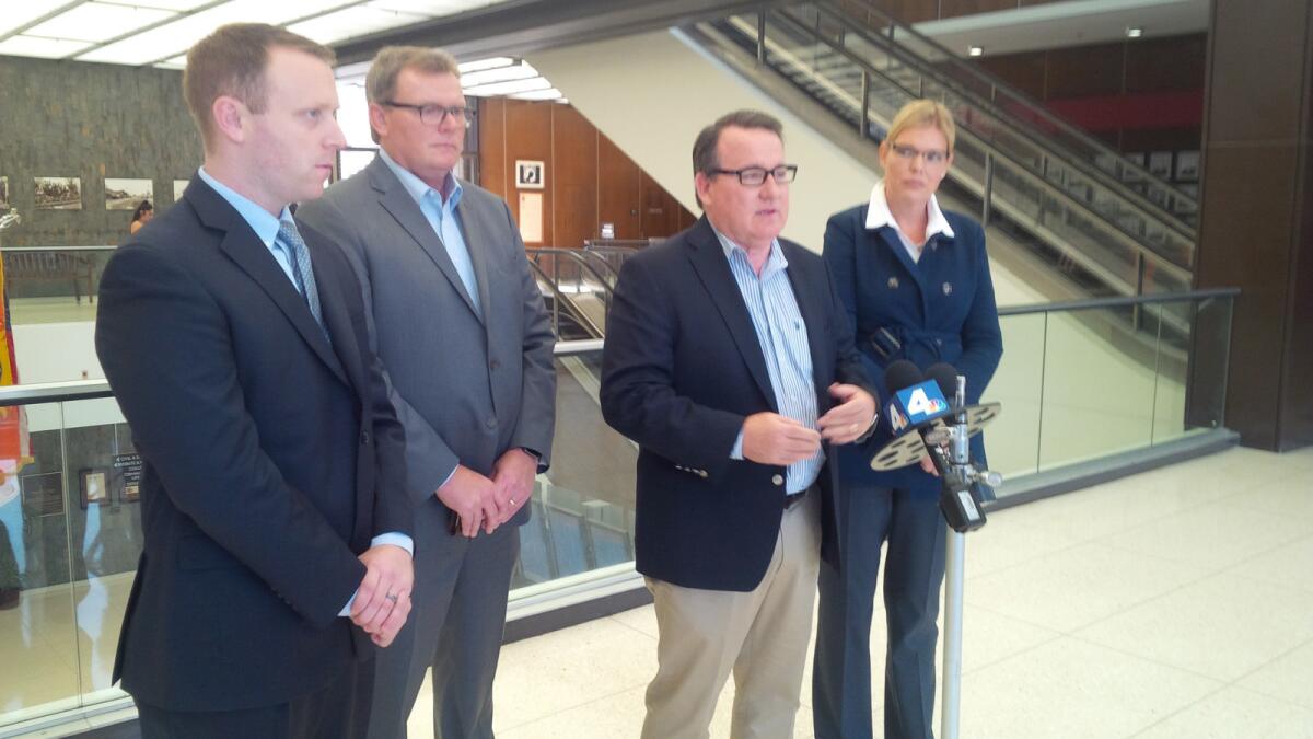 From left, attorney Alex Cunny, former Costa Mesa Mayor Steve Mensinger, Costa Mesa Mayor Pro Tem Jim Righeimer and Lene Righeimer speak to media Friday in Santa Ana's Orange County Superior Court after the sentencing of a former Riverside police detective convicted of illegally tracking the councilmen in 2012.