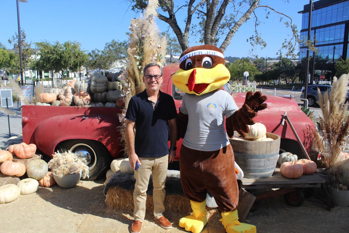 Craig Benedetto with the Father Joe's Thanksgiving 5K mascot.