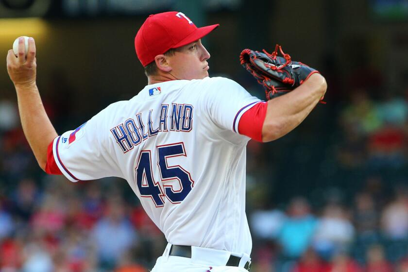 Texas Rangers pitcher Derek Holland throws during the first inning against the Baltimore Orioles on Monday.