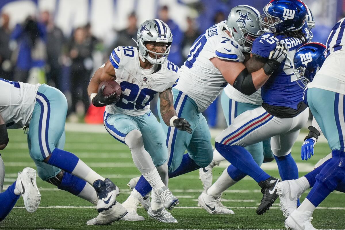 Dallas Cowboys running back Tony Pollard runs with the ball during a game against the New York Giants.