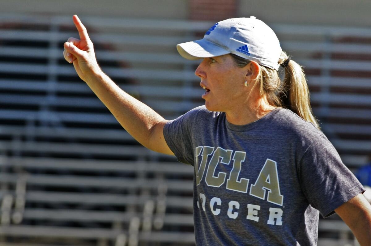 UCLA women's soccer coach Amanda Cromwell gives instructions to the Bruins during a practice in 2014.