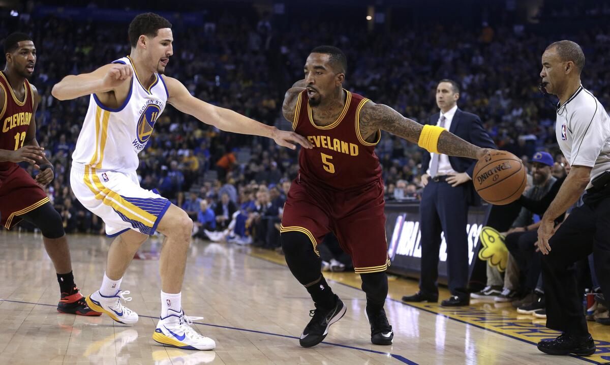 Cavaliers' guard J.R. Smith drives against Warriors' guard Klay Thompson in the first half Friday night.