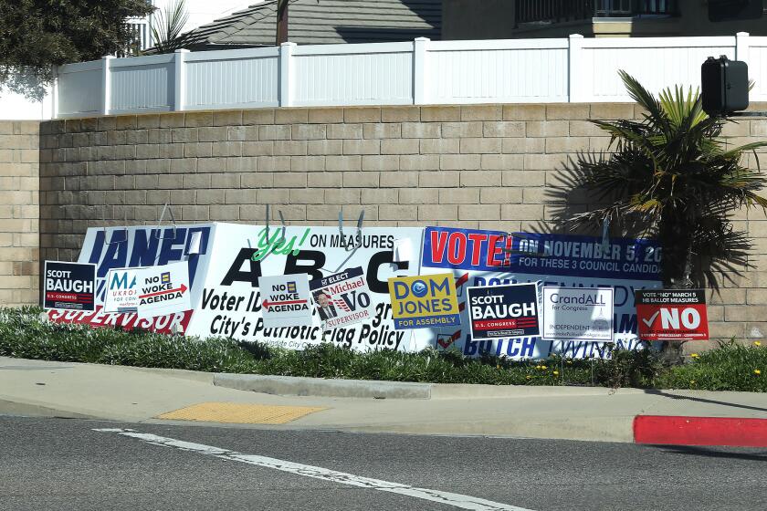 Political signs on street corners in Huntington Beach. Voters have three charter amendment measures - Measures A, B and C - to consider for the primary election on March 5.