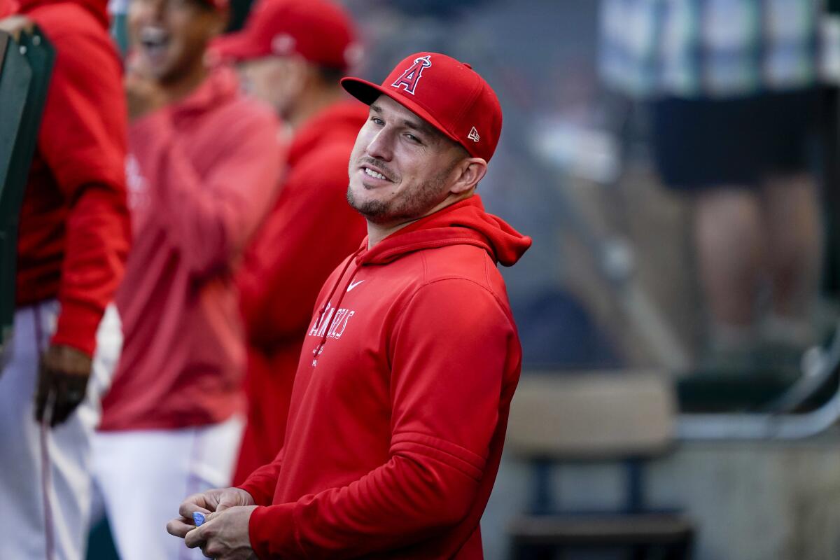 Angels center fielder Mike Trout stands in the dugout before a 2024 game 
