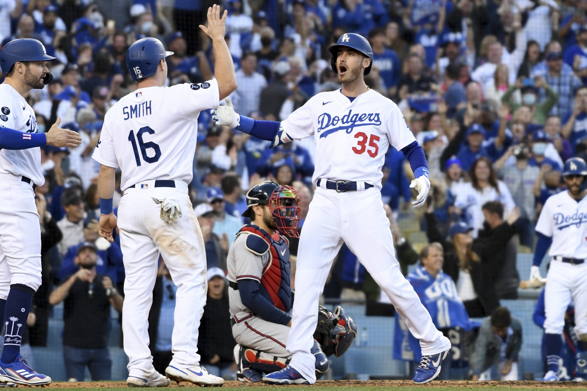 Dodgers' Cody Bellinger, right, celebrates with Will Smith and AJ Pollock after a three-run home.