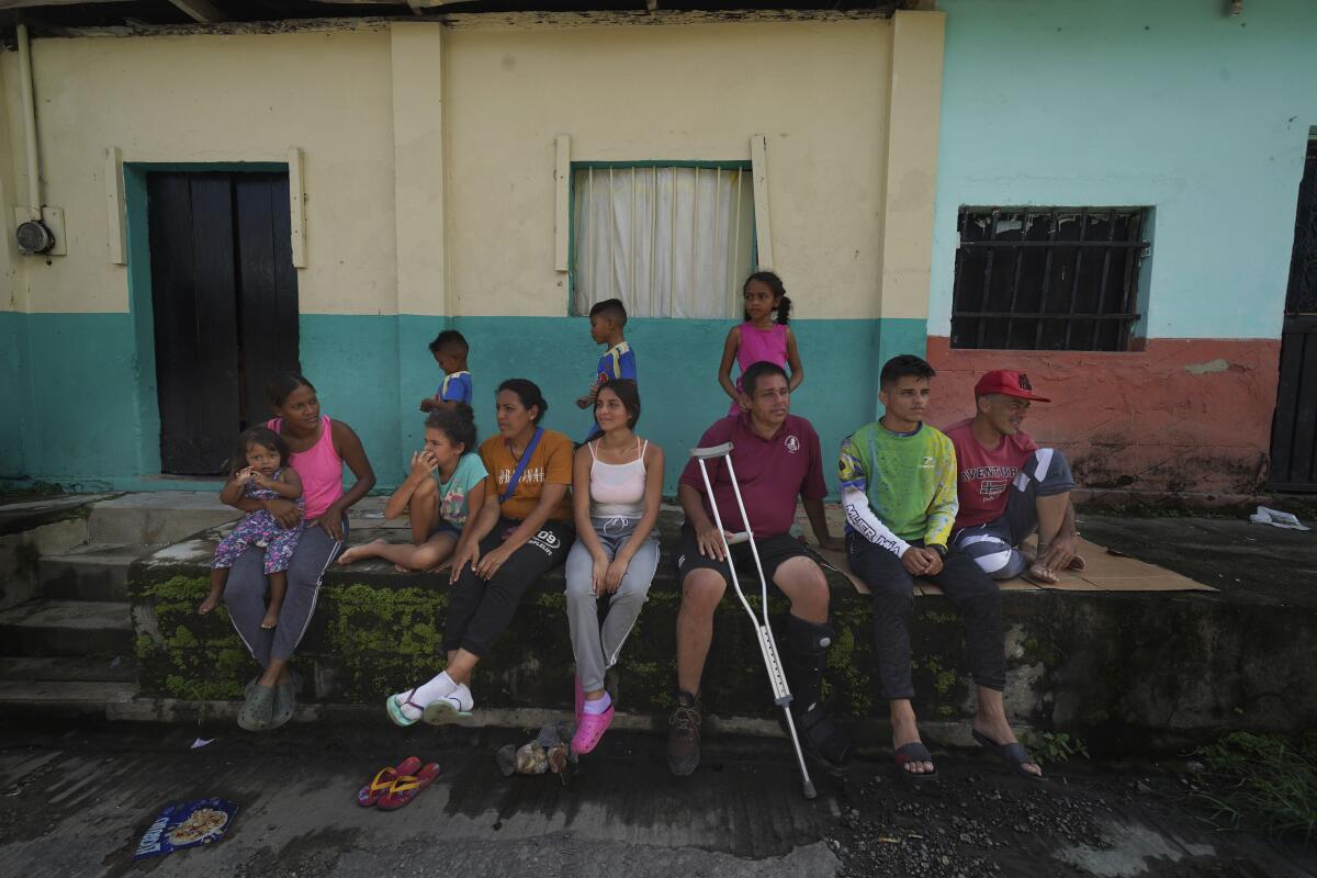 People sit in front of a building.