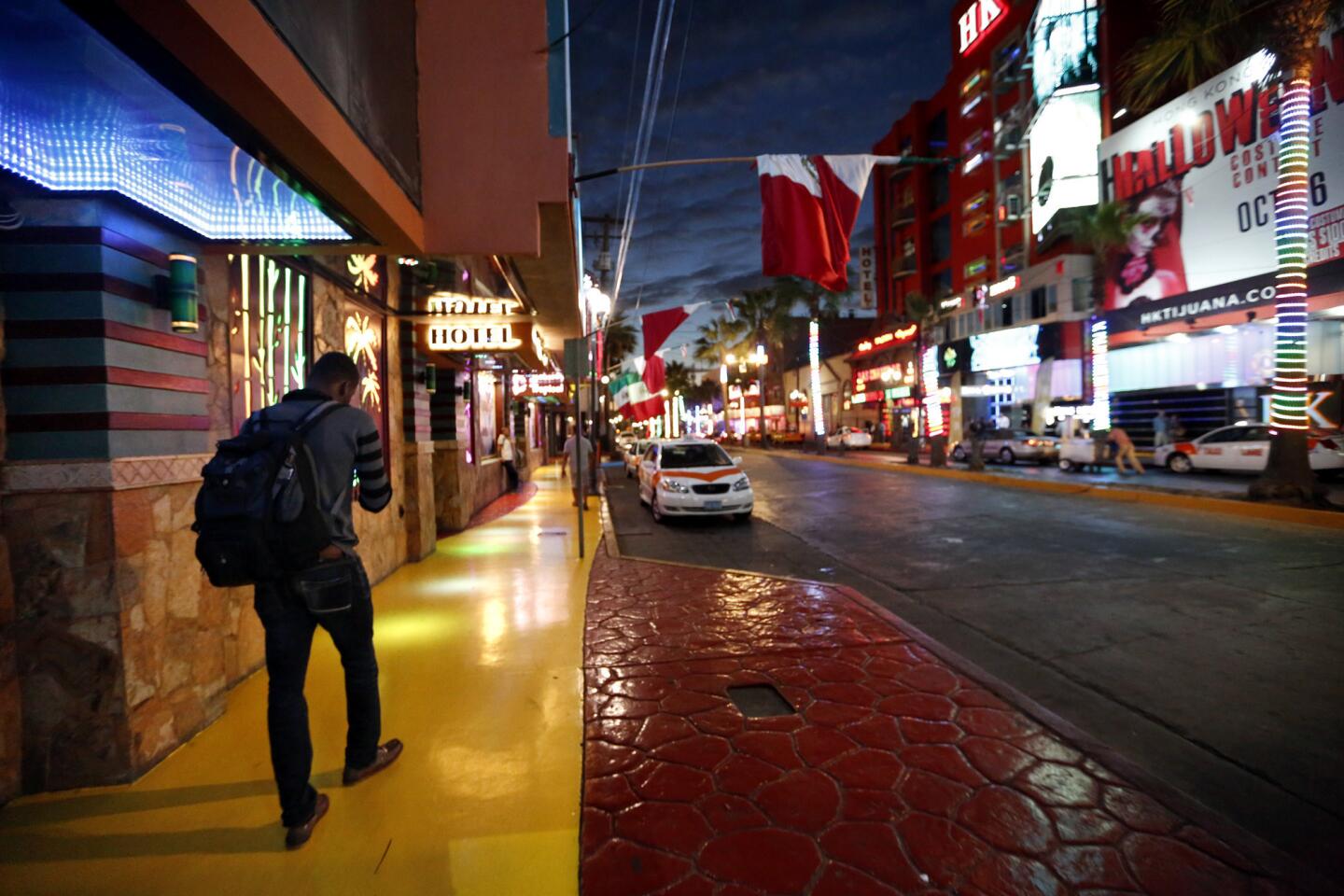 Nertho Thermitus, a migrant from Haiti, walks through Tijuana’s Red Light District in the early morning on his way to the U.S. border.