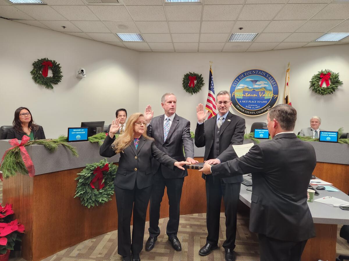 Fountain Valley City Council members Kim Constantine, Patrick Harper and Jim Cunneen, from left, are sworn in on Tuesday.