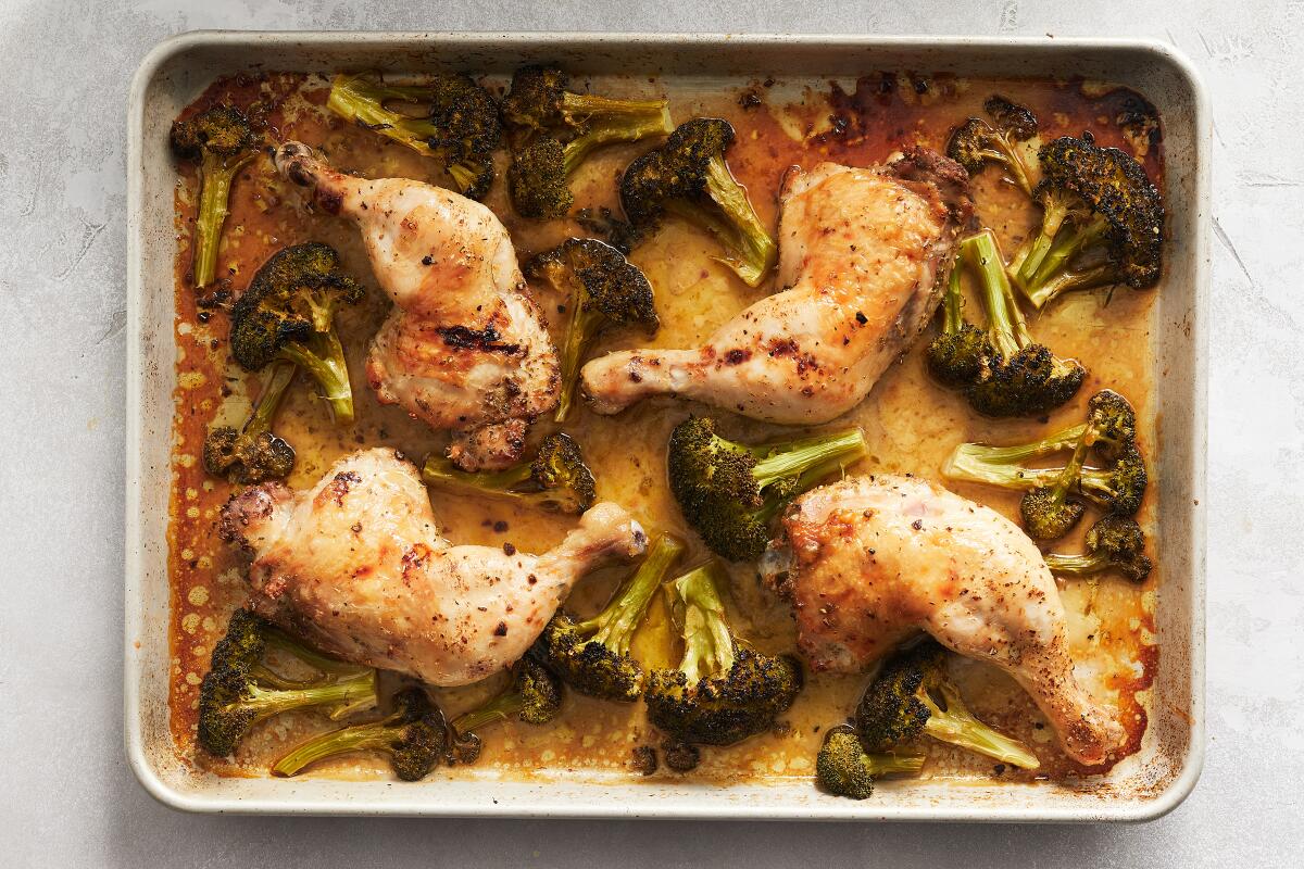 A sheet pan holds h\Habanero chicken and broccoli.