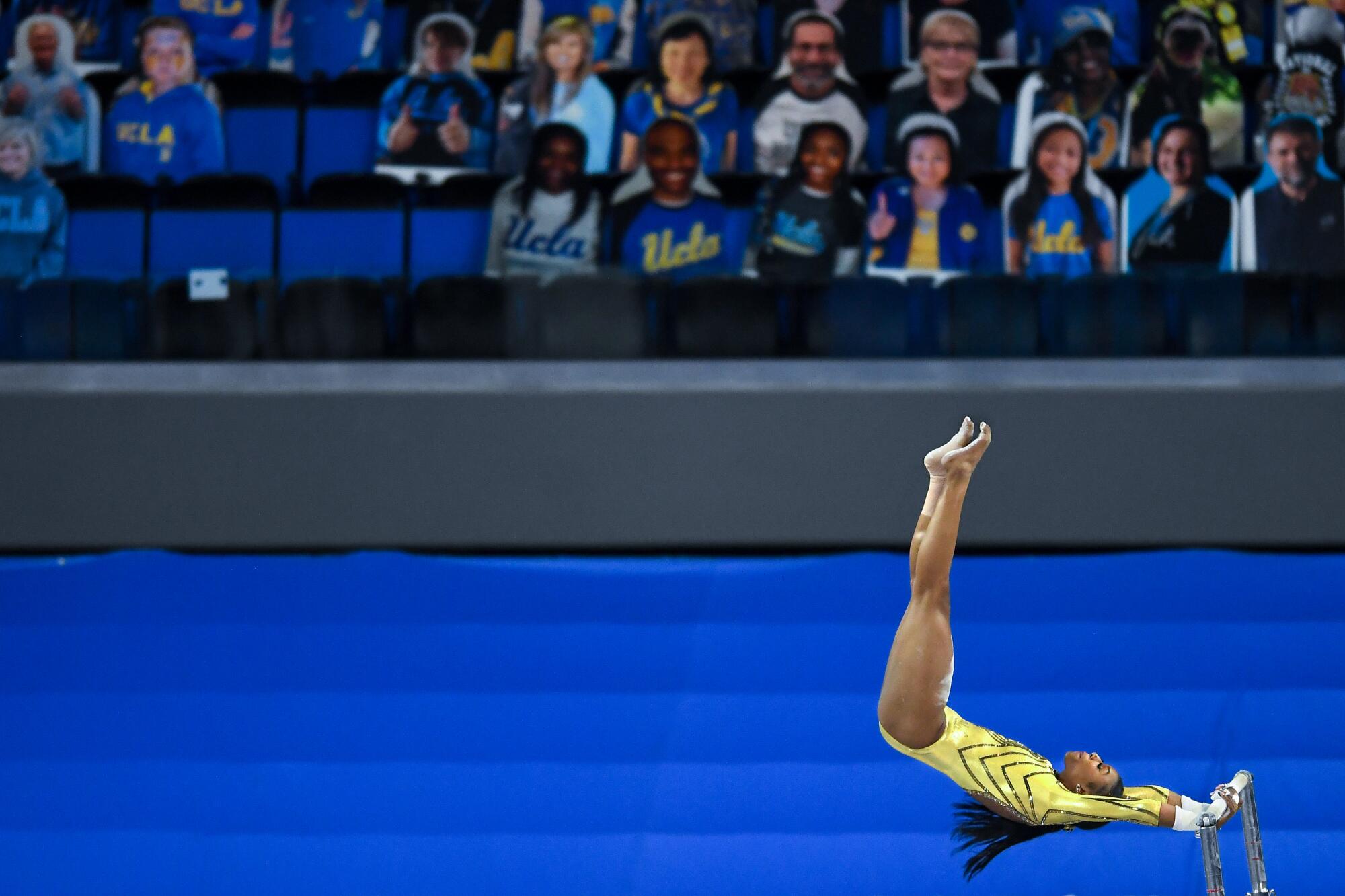 Nia Dennis competes on the uneven bars.