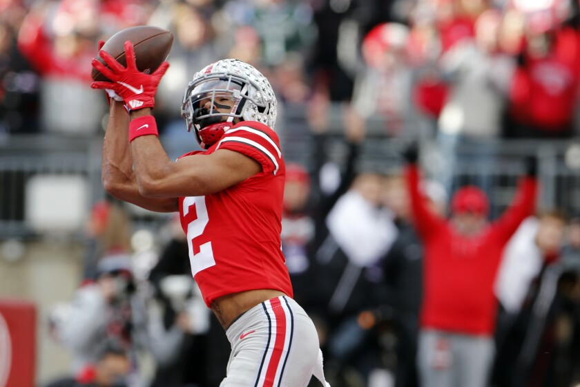 Ohio state receiver Chris Olave receives a touchdown pass against the state of Michigan in December.