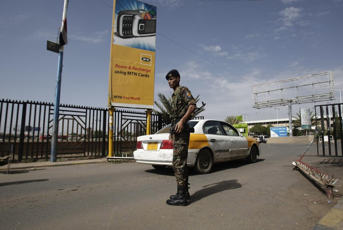 A policeman stands guard at the entrance to Sana International Airport in Yemen.