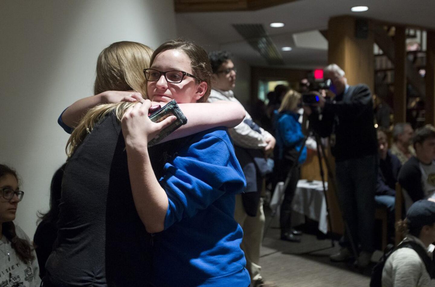 Rachel Trout, 16, a student at Blue Valley High School, gets a hug from a a friend after addressing a crowd gathered to mourn the Jewish shooting victims at St. Thomas the Apostle Episcopal Church in Overland Park, Kan. On Sunday, Trout was inside the Jewish Community Center of Greater Kansas City, the first of two sites to be targeted by a gunman.