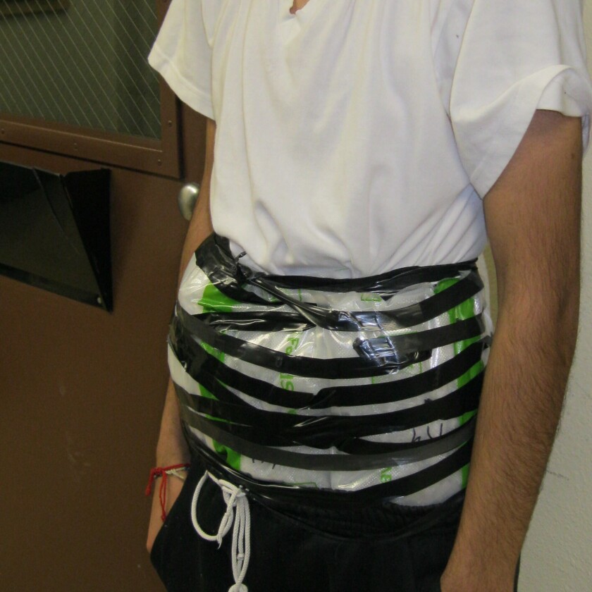 This Monday, Jan. 13, 2020, photo provided by U.S. Customs and Border Protection San Diego shows a 14-year-old with methamphetamine strapped to his body after he was arrested at a border checkpoint in Jamul, east of San Diego. The boy, two other teens and an adult driver were arrested after a car was stopped Monday night at the State Route 94 checkpoint in Jamul, and a drug-sniffing dog gave an alert, according to a U.S. Customs and Border Patrol statement. The Border Patrol has warned that drug cartels appear to be increasingly hiring teenagers to smuggle drugs. (U.S. Customs and Border Protection San Diego via AP)