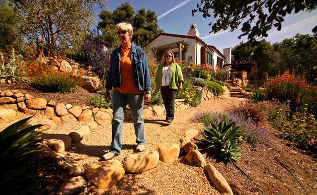 Dawn Close, left, and Margie Grace, principals of Grace Design Associates in Santa Barbara, walk one of the new paths at the Johnsons' home. Grace, who oversees design of the firm's projects, said she wanted to create a garden that reduced future fire threat, required little watering and provided habitat for butterflies, birds and other wildlife.