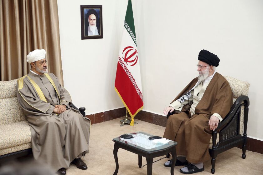 In this picture released by the office of the Iranian supreme leader, Supreme Leader Ayatollah Ali Khamenei, right, meets with Oman's Sultan Haitham bin Tariq Al Said, in Tehran, Iran, Monday, May 29, 2023. A portrait of the late Iranian revolutionary founder Ayatollah Khomeini hangs on the wall. (Office of the Iranian Supreme Leader via AP)