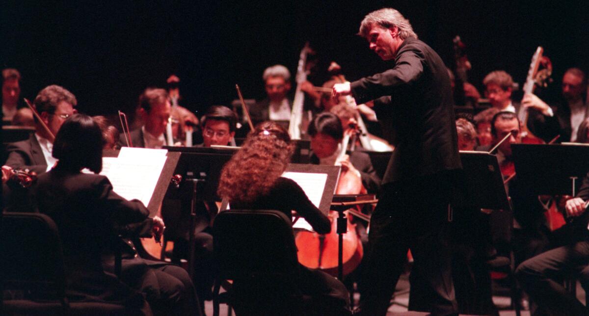 Carl St.Clair conducts during a performance by the Pacific Symphony and the Pacific Chorale.