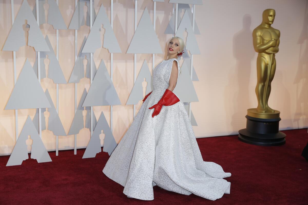 The red gloves that set off a thousand memes: Lady Gaga arrived at the 2015 Oscars in a white Azzedine Alaïa gown and attention-getting accessories.