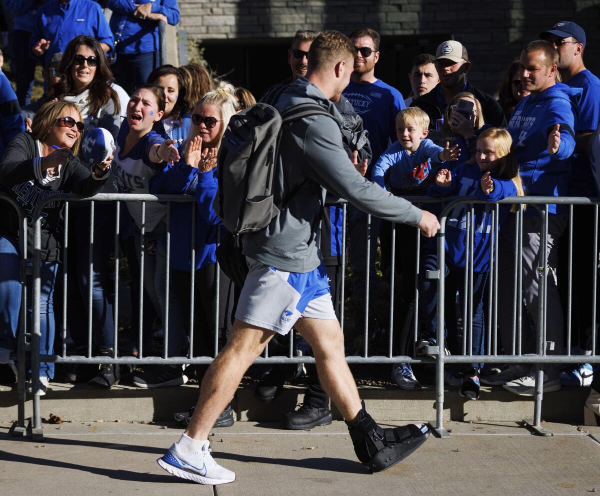 Injured Kentucky quarterback Will Levis greets fans before an NCAA college football game against South Carolina in Lexington, Ky., Saturday, Oct. 8, 2022. (AP Photo/Michael Clubb)