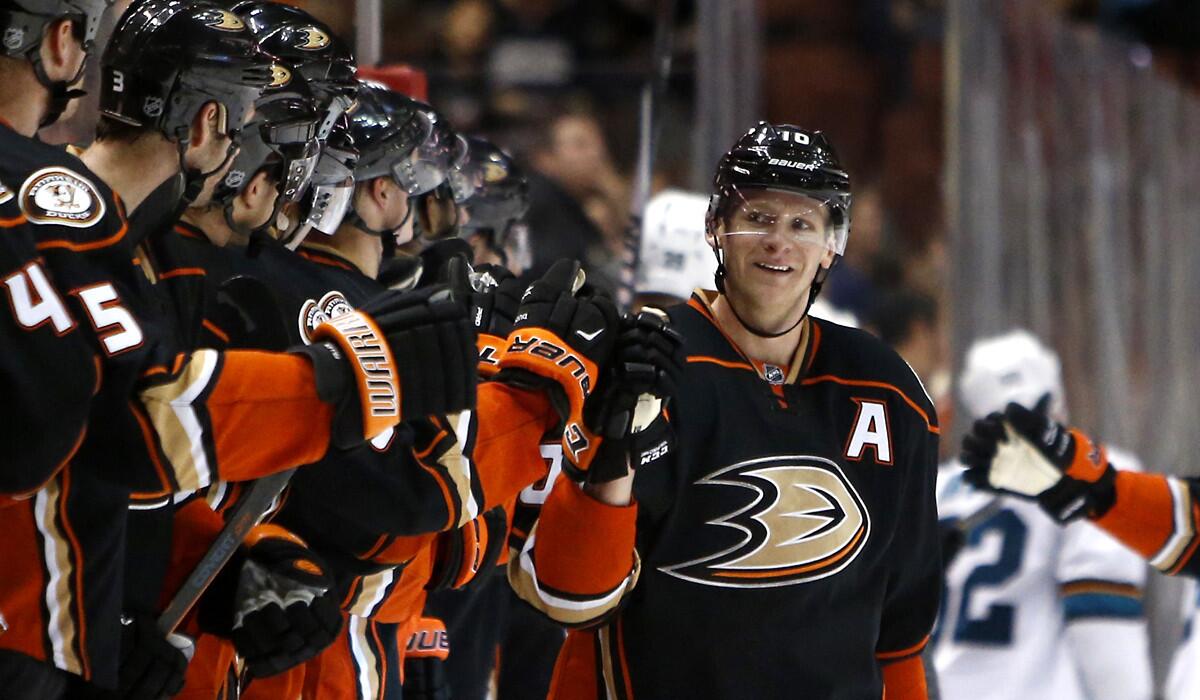 Ducks winger Corey Perry is congratulated after scoring in the third period against the San Jose Sharks on Saturday night.