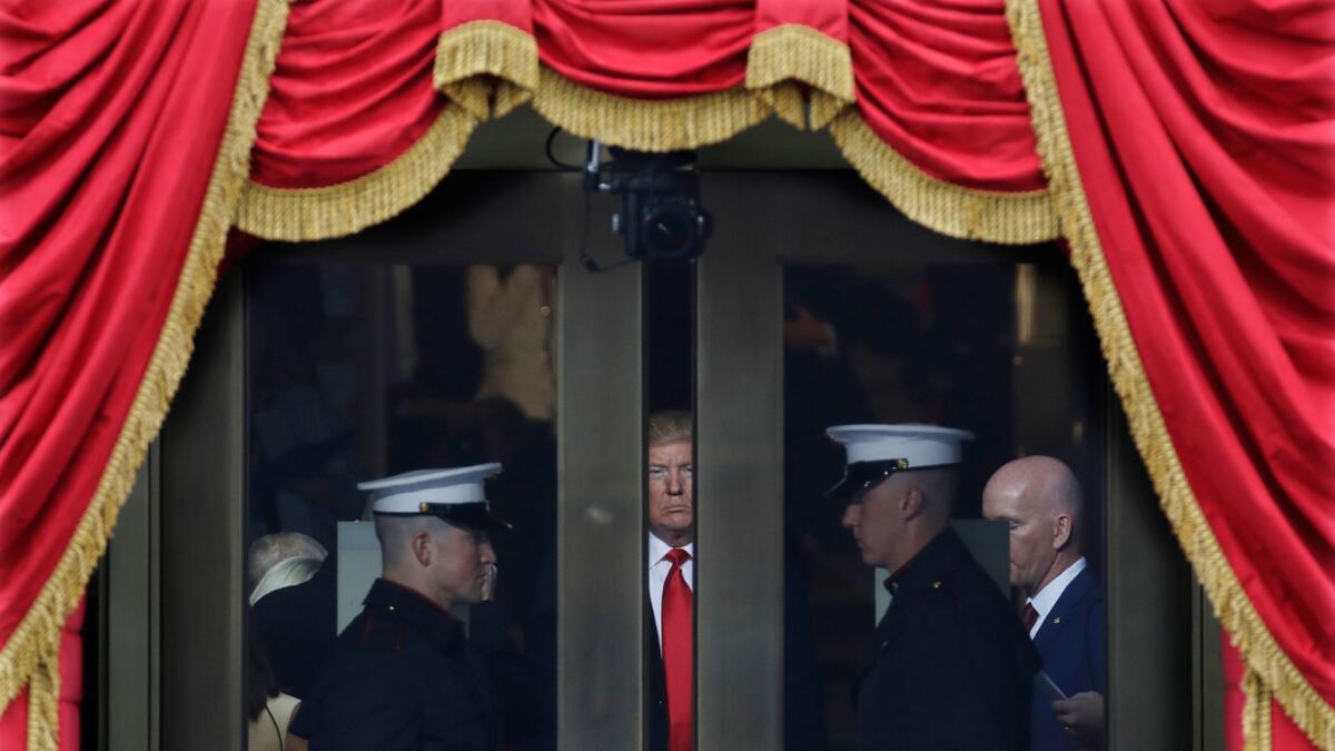 Donald Trump waits to step out onto the portico of the U.S. Capitol for his inauguration in January.