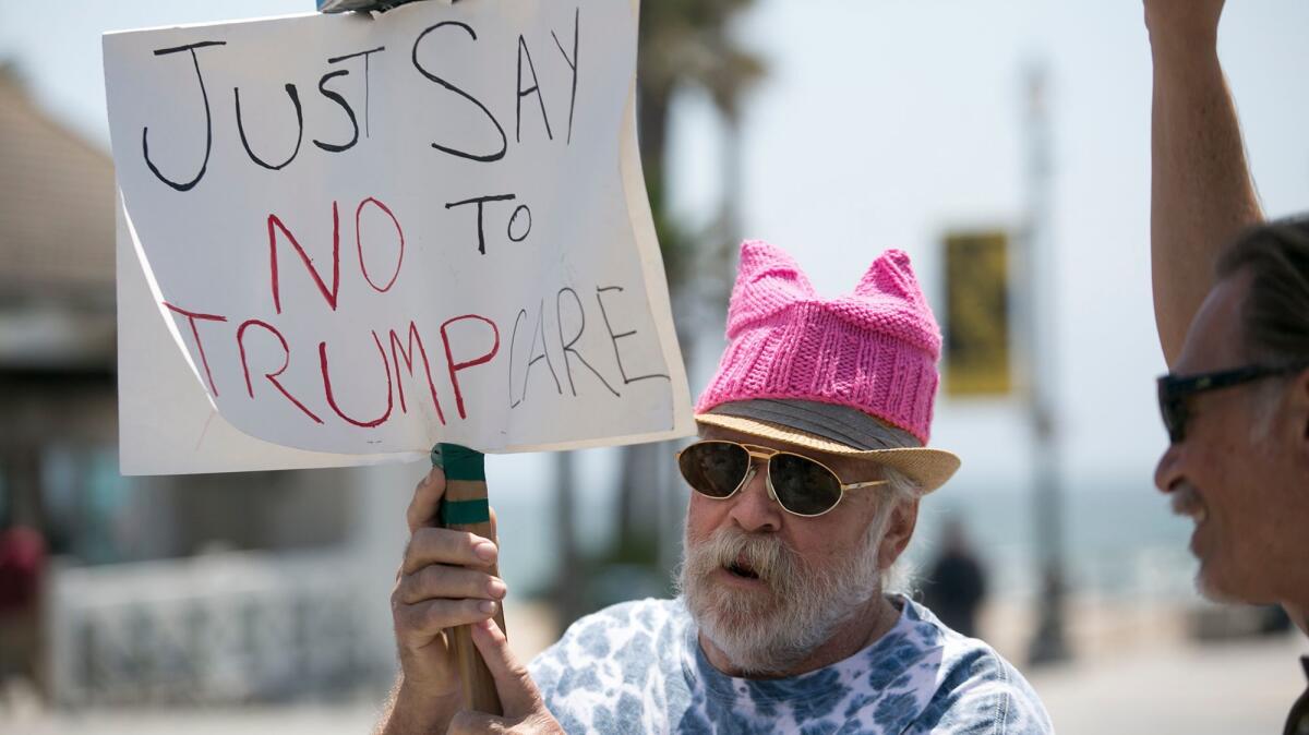 Mike Fowler protests outside Rep. Dana Rohrabacher's office in Huntington Beach on Tuesday.