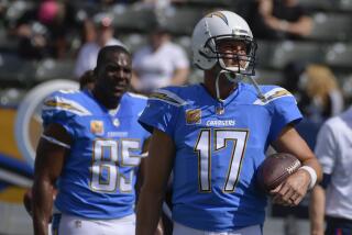 Chargers Antonio Gates and Philip Rivers stand on the sideline before a game in 2018.