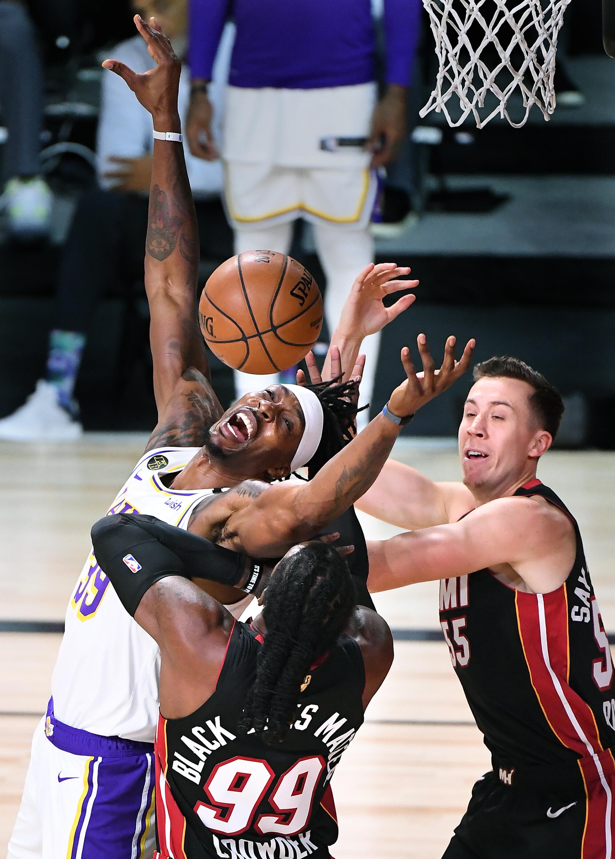 Lakers center Dwight Howard is fouled by Heat forward Duncan Robinson on an entry pass during Game 3.