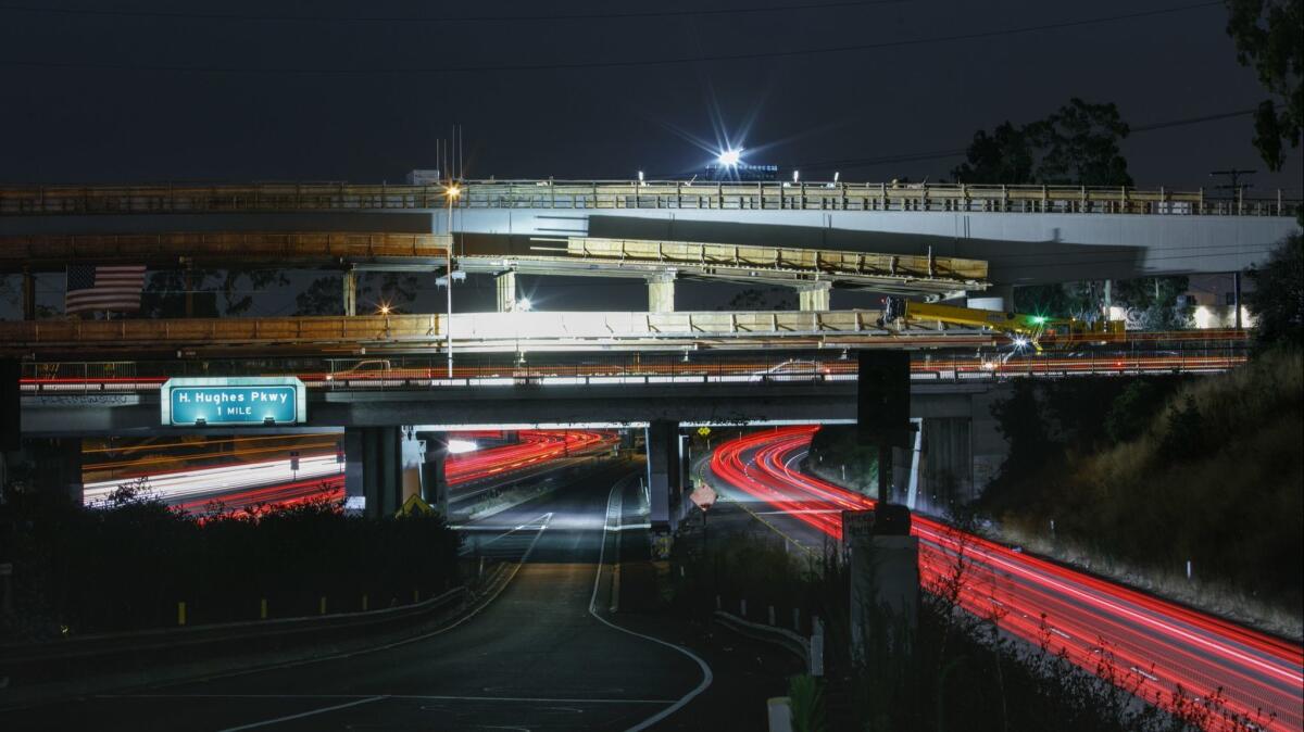 Construction crews work near Manchester Boulevard as cars whiz past on the 405 Freeway in 2017.