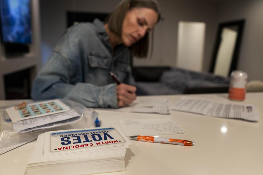 DENVER, COLORADO - August 16, 2022: At her home in her kitchen political activist Jen Helms writes campaign postcards in Denver, Colorado Tuesday August 16, 2022. (Melina Mara/The Washington Post via Getty Images)