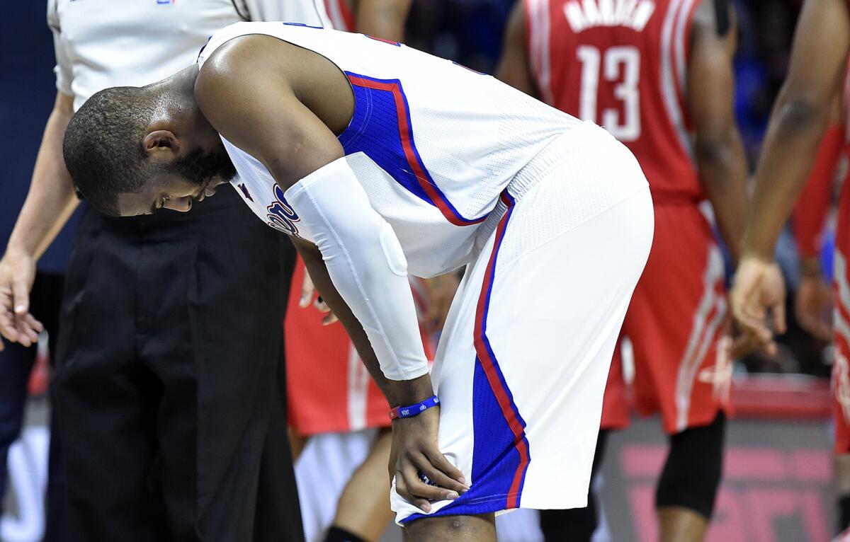 Clippers point guard Chris Paul tries to gather himself late in the fourth quarter of Game 6 on Thursday night at Staples Center.