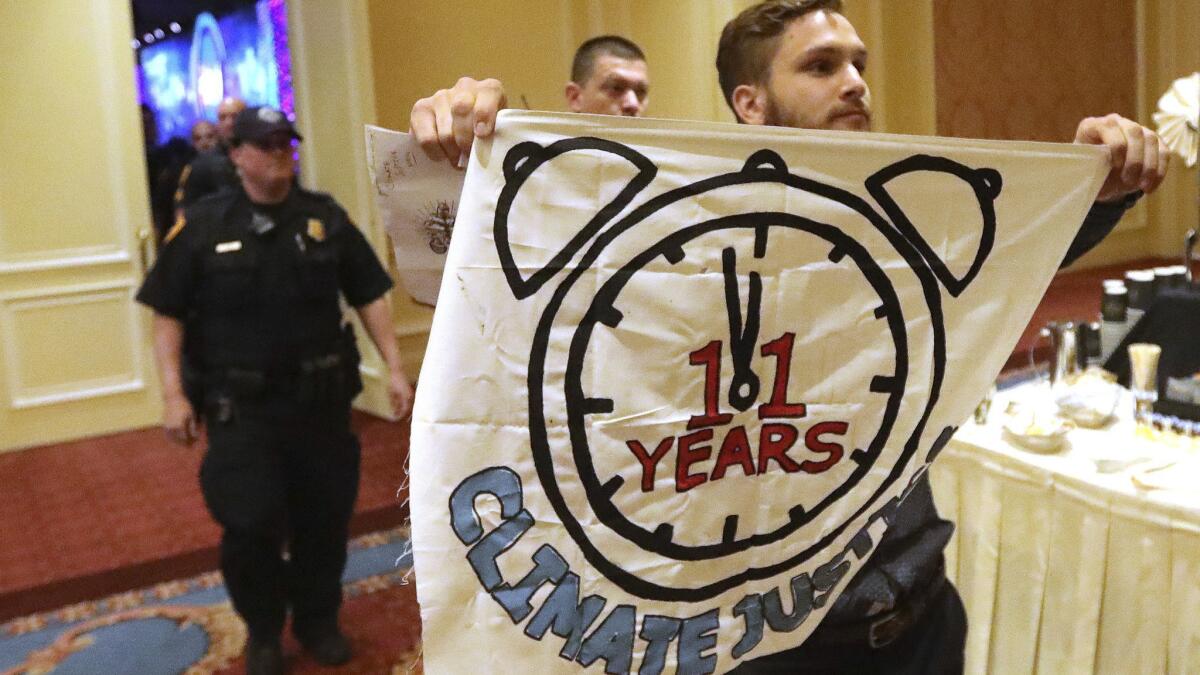 About 25 protesters were escorted out by police after interrupting an energy conference Thursday in Salt Lake City.