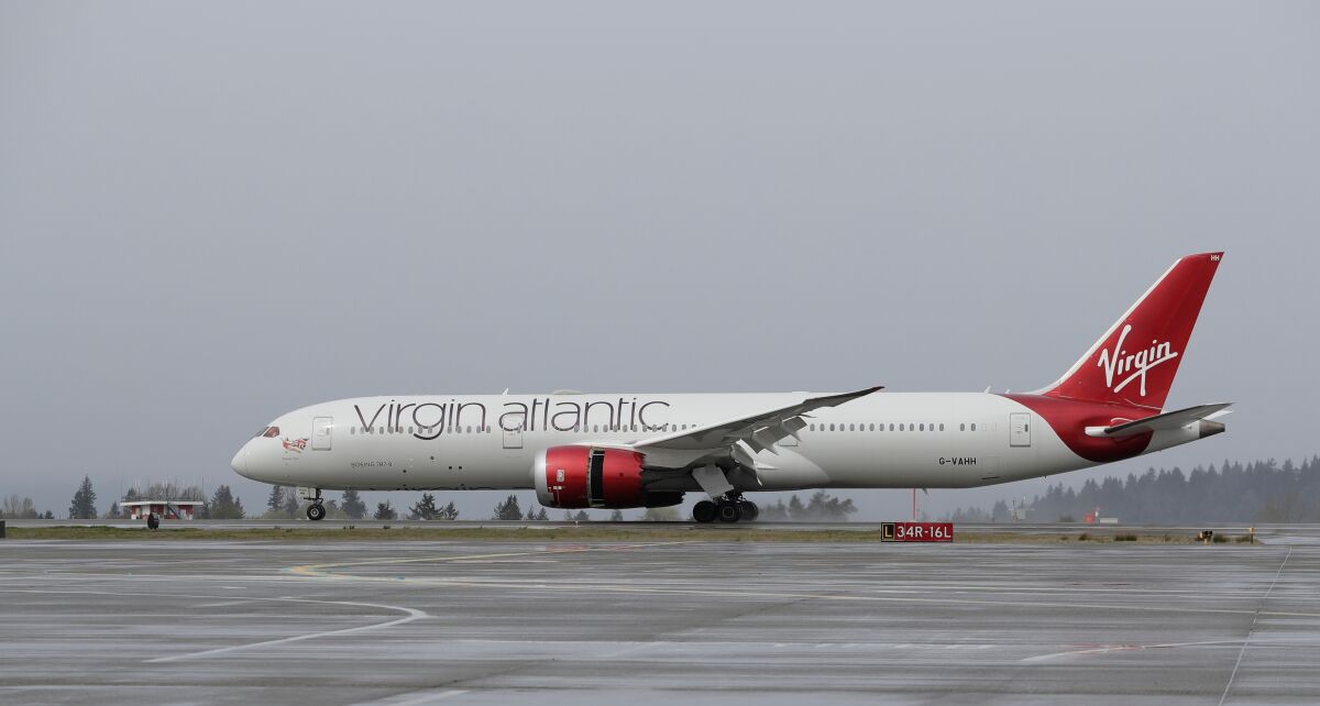 A Virgin Atlantic Airways plane taxis Friday, April 13, 2018, at the Seattle-Tacoma International Airport in Seattle. Virgin Atlantic has received 400 million pounds of new funding from its shareholders to help the airline ride out the coronavirus pandemic. In a statement Monday, Dec. 13, 2021 it said its shareholders, Richard Branson’s Virgin Group and Atlanta-based Delta Air Lines, will provide the money in line with their stakes. (AP Photo/Ted S. Warren)
