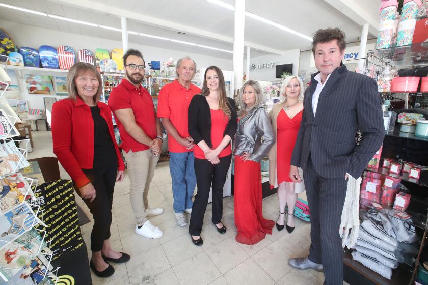 Store manager Kim Denger, Adel Saleh, Brad Moses, Sandra Stecklein, Pharmacist Suzanne Light, Nina Morlan, and owner Jeff Ford, from left, make up the team and staff at Balboa Pharmacy on the Balboa Peninsula in Newport Beach on Thursday.