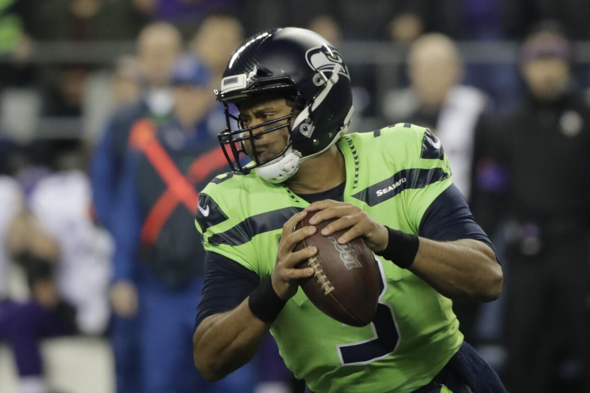 Seattle Seahawks quarterback Russell Wilson drops to pass against the Minnesota Vikings during the first half on Monday in Seattle.