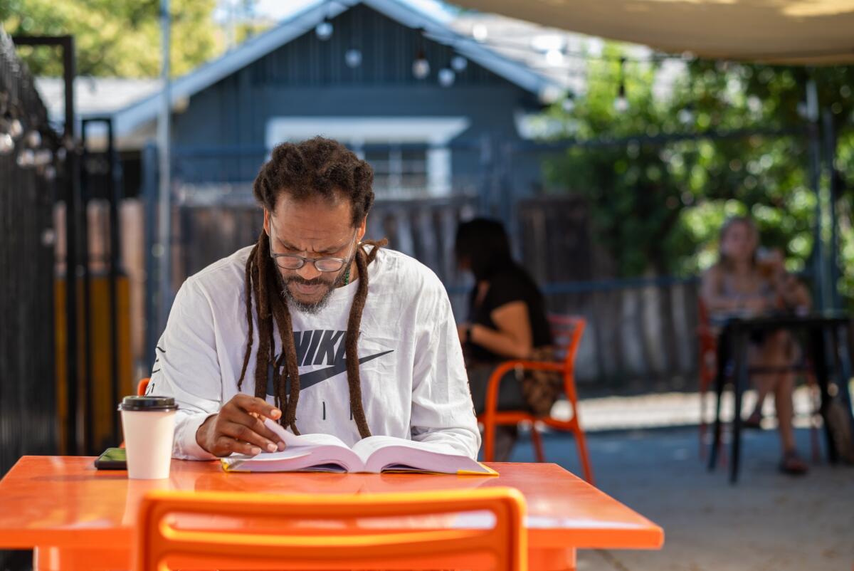 Daawud Smith, of San Bernardino, reads at Slow Bloom Coffee Cooperative in Redlands. 