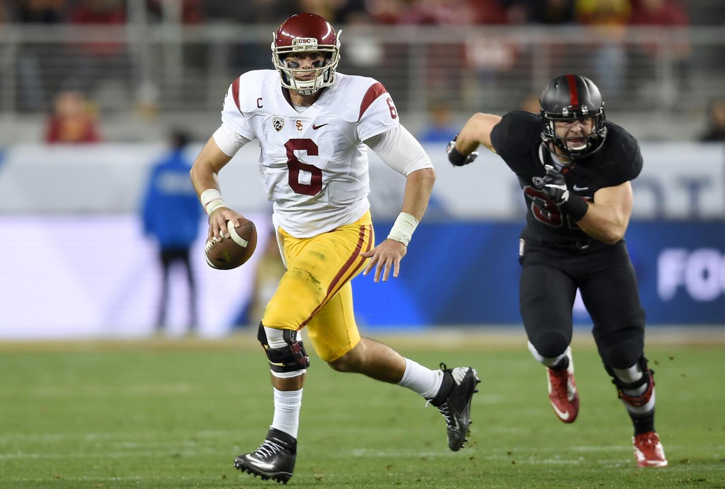 USC's Cody Kessler scrambles with the ball against Stanford during the second quarter of the Pac-12 Championship game at Levi's Stadium on Saturday.