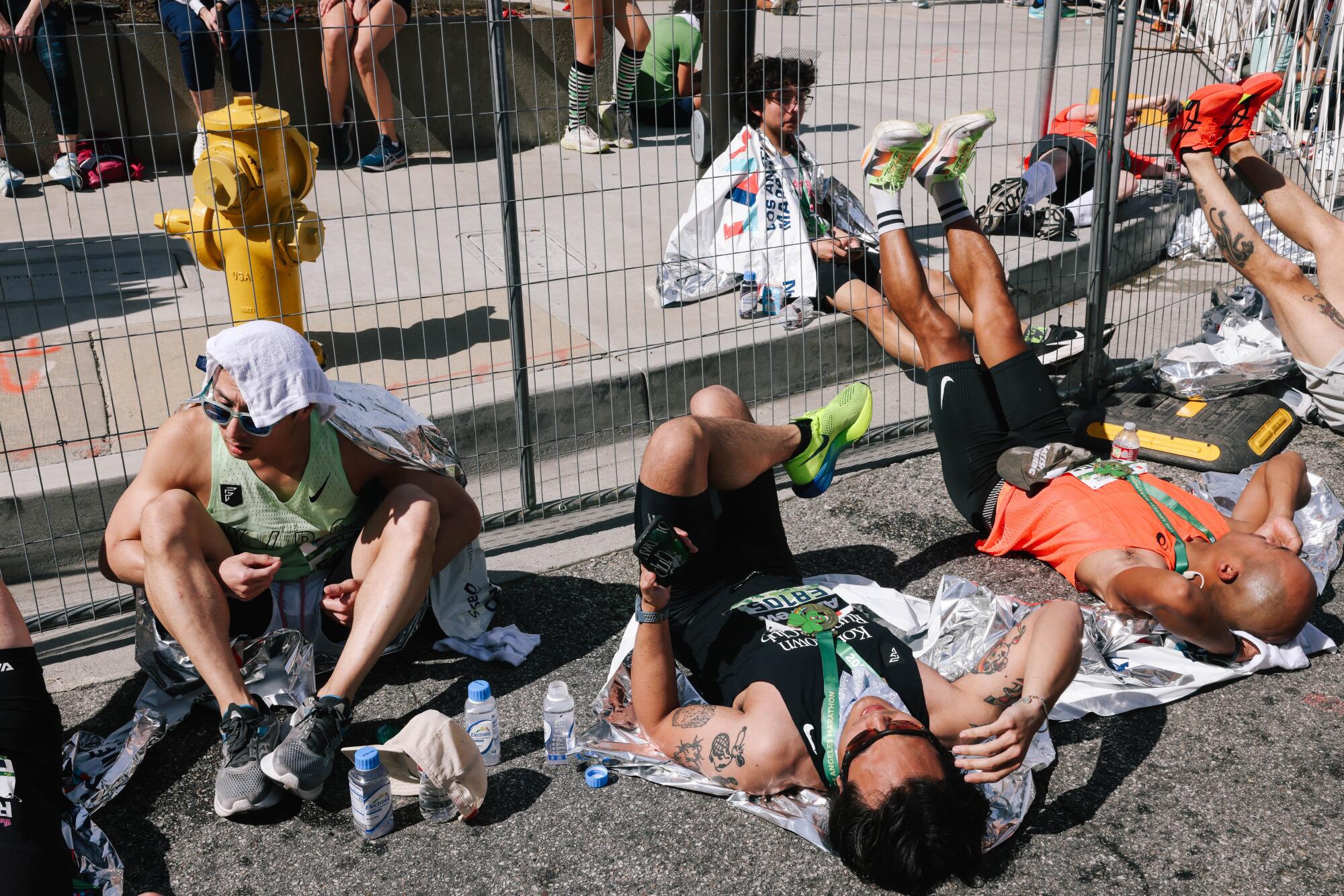 The runners rest after crossing the finish line.