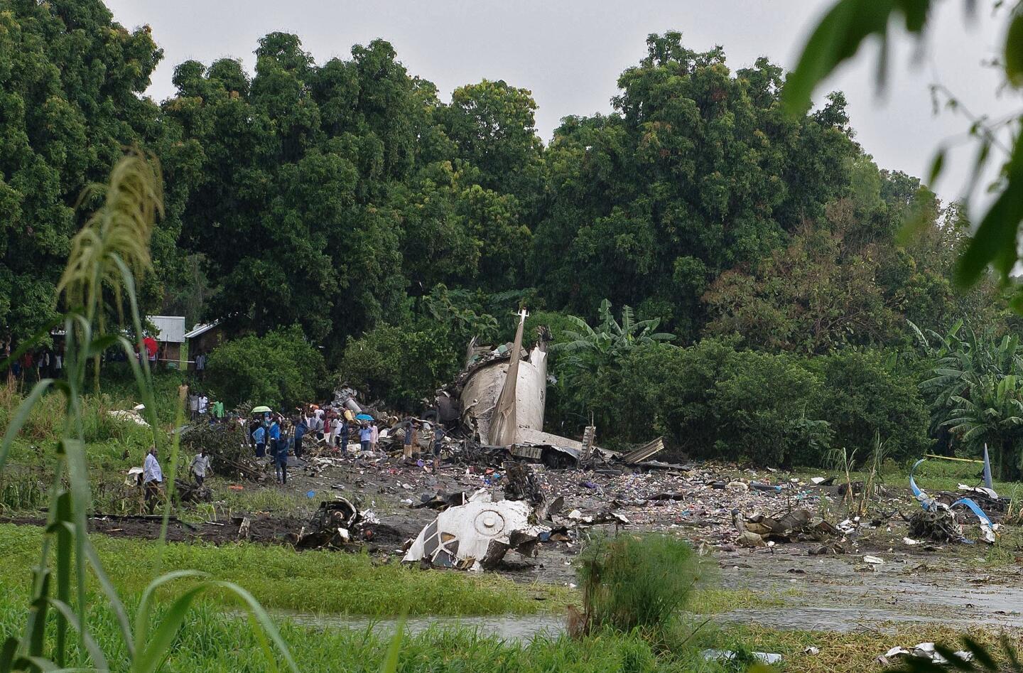People gather at the site where a cargo plane crashed into a small farming community on a small island in the White Nile river, close to Juba airport in the Hai Gabat residential area in South Sudan, on Nov. 4, 2015.