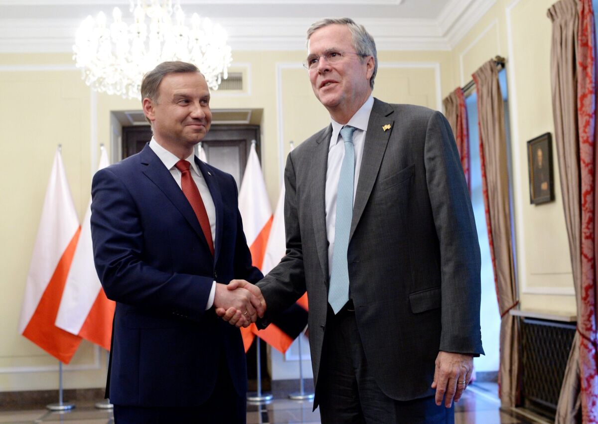 Polish President-elect Andrzej Duda, left, greets Jeb Bush in Warsaw on June 11.